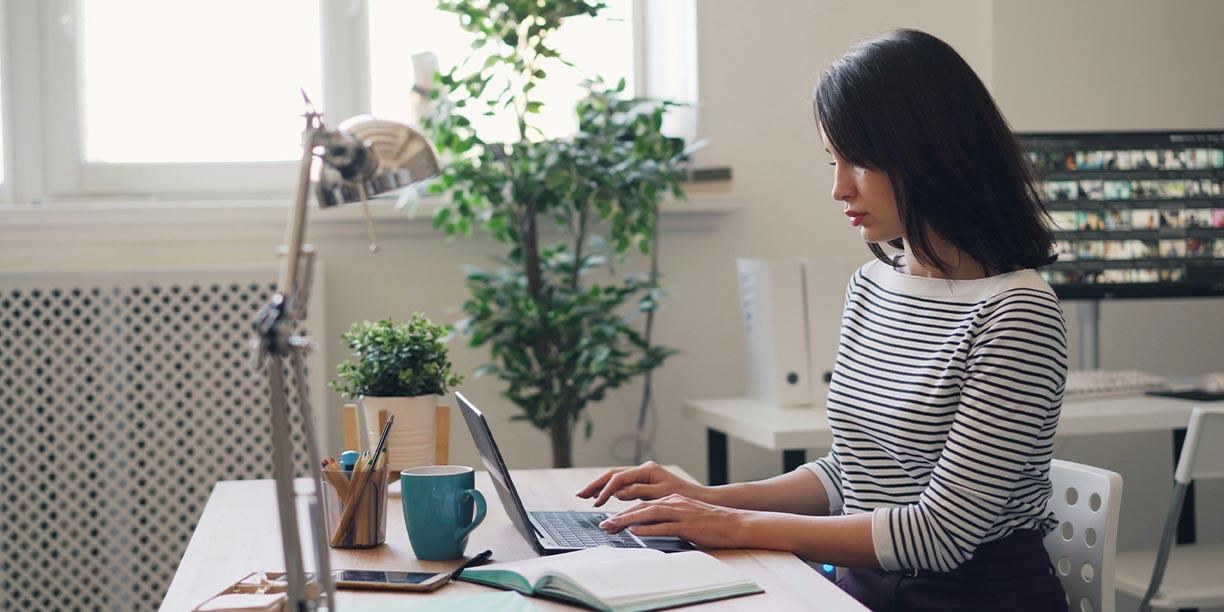 Girl sitting at desk working on computer