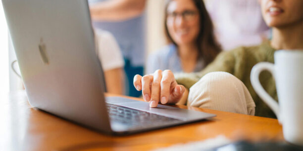 People sitting at a desk working on their crowdfunding website