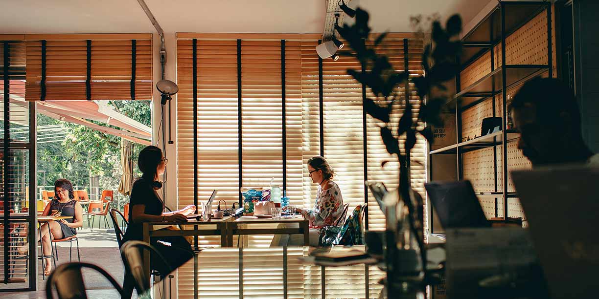 People working independently at a coffee shop