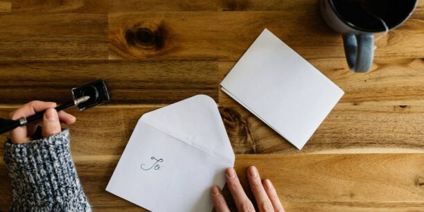 Person writing donor thank you letters at their desk